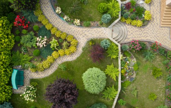 Garden with walkways and green grass. Photo taken from above drone.